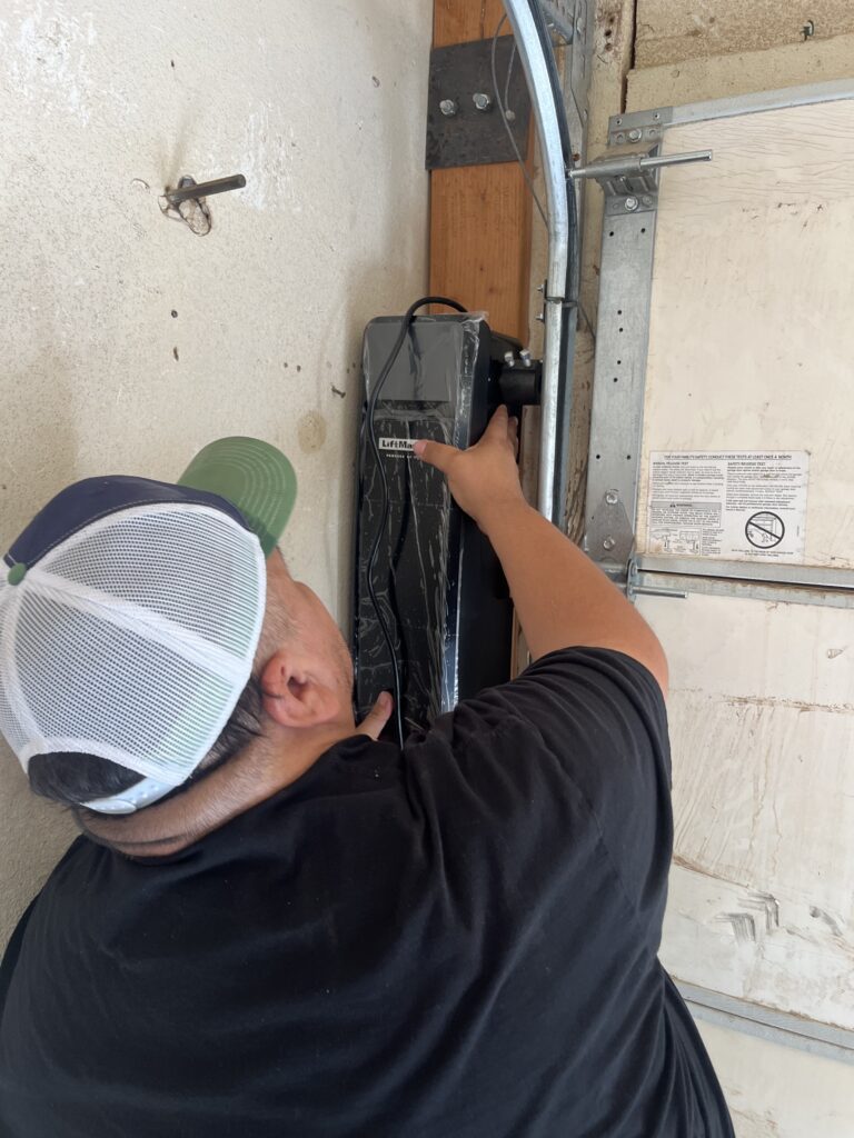 Garage Door Technician Compleing a Garage Door Repair in Horizon City, TX
